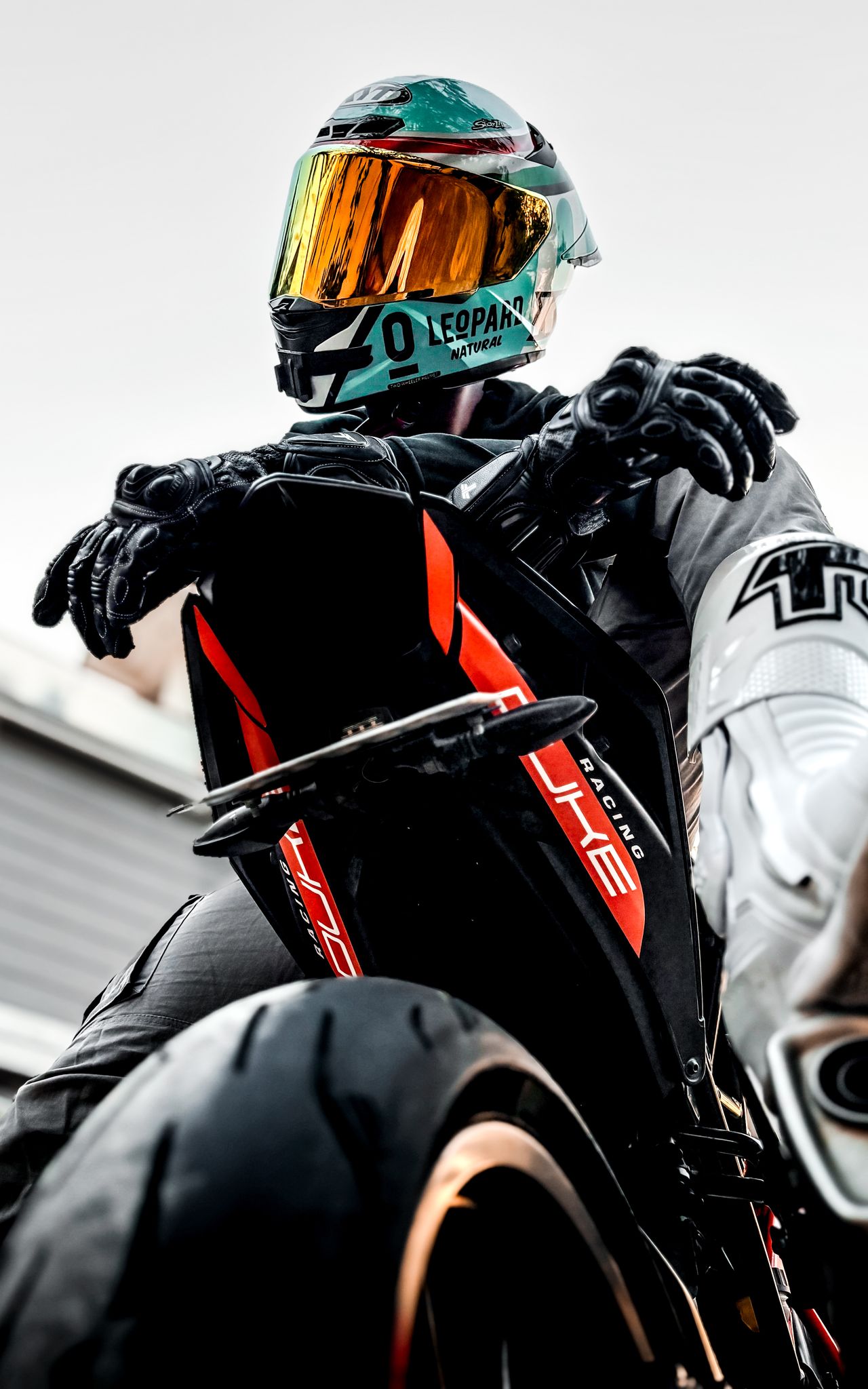 Editorial photograph — rider on a coastal road, 4:5 portrait